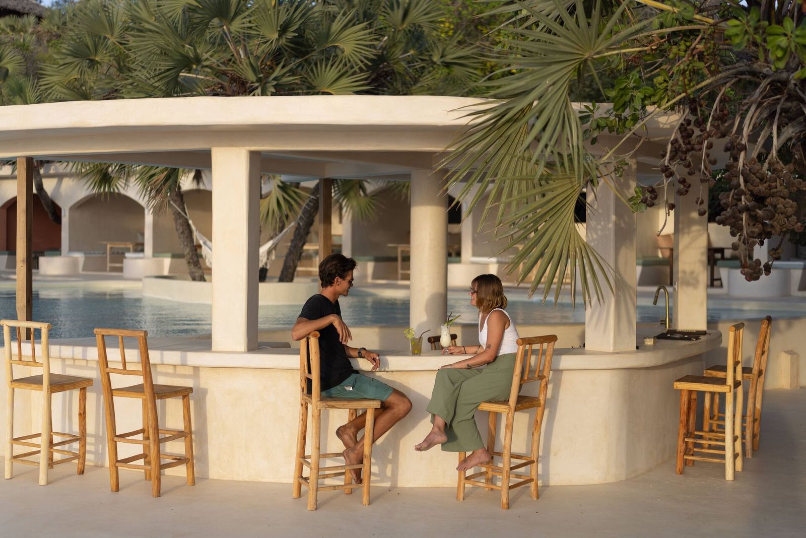 The lounge at The Cabanas, makuti thatch, dark timber and woven textures
