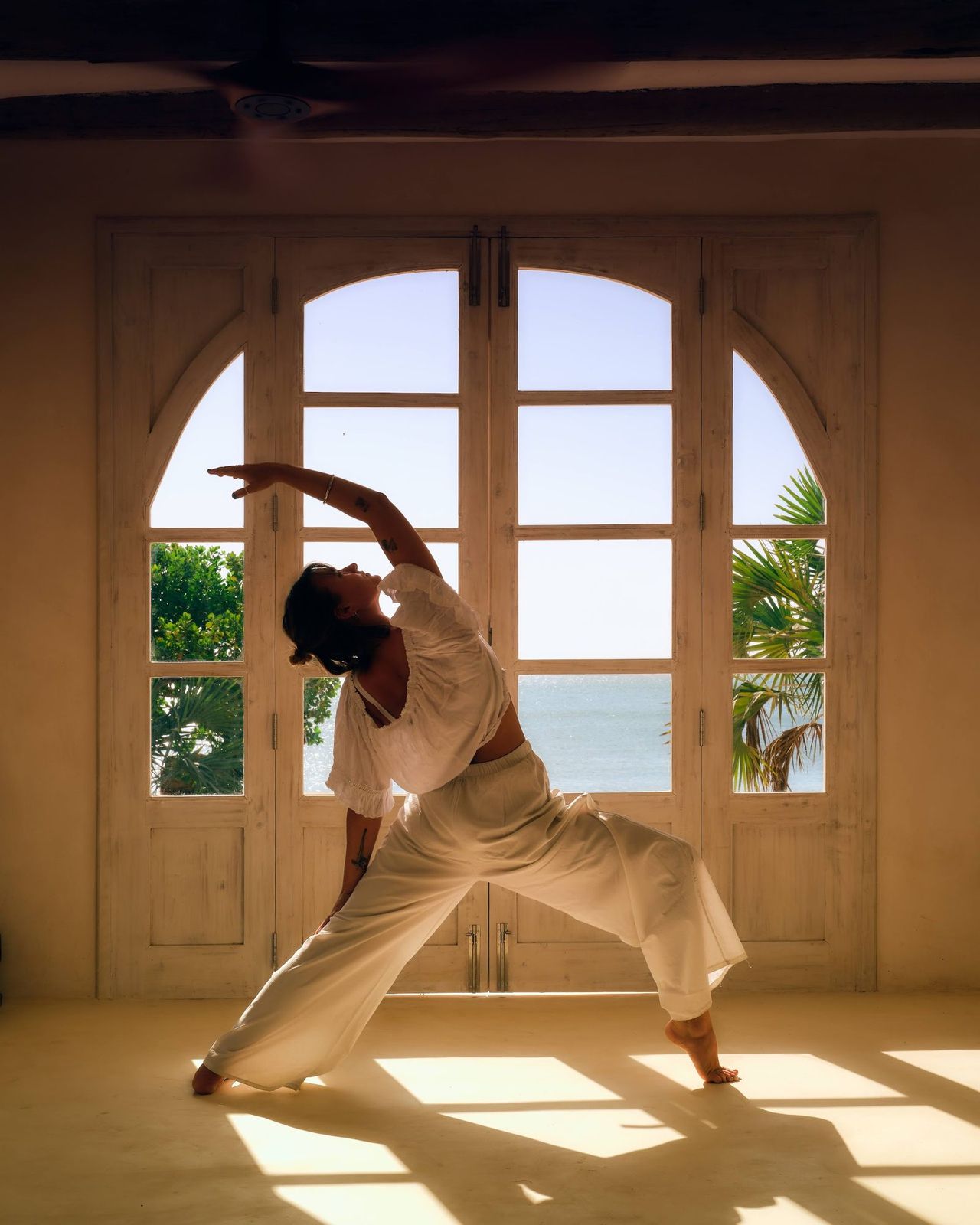 A morning yoga practice on the deck, quiet movement, ocean light