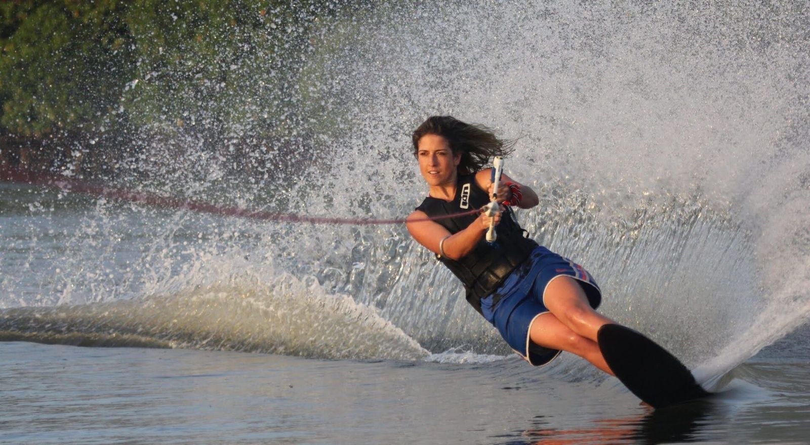 Waterskiing on calm seas at golden hour